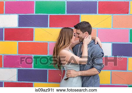 Couple in front of colourful tiled wall hugging, Coney island, Brooklyn, New York, USA View Large Photo Image Stock Photograph - Couple in front of colourful tiled wall hugging, Coney island, Brooklyn, New York, USA. Fotosearch