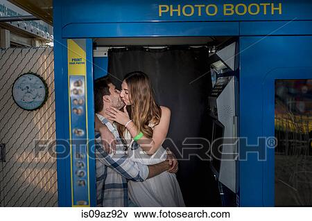 Couple in photo booth kissing, Coney island, Brooklyn, New York, USA View Large Photo Image Stock Photo - Couple in photo booth kissing, Coney island, Brooklyn, New York, USA. Fotosearch