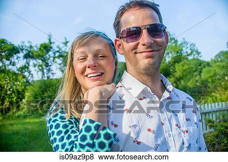 Couple looking at camera smiling View Large Photo Image Stock Photo - Couple looking at camera smiling. Fotosearch