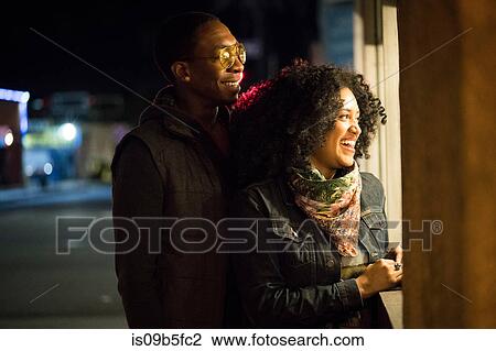 Couple looking through shop window at night, Los Angeles, California, USA View Large Photo Image Stock Image - Couple looking through shop window at night, Los Angeles, California, USA. Fotosearch