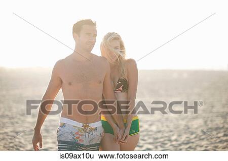 Couple on beach holding hands View Large Photo Image Stock Photograph - Couple on beach holding hands. Fotosearch