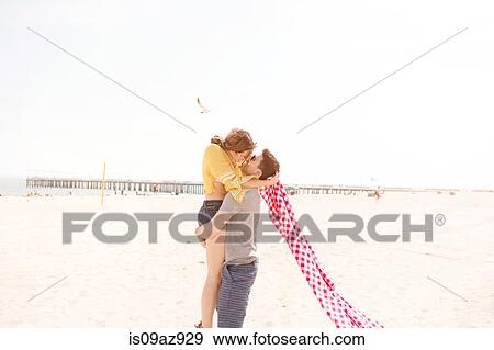 Stock Photo - Couple on beach kissing, Coney island, Brooklyn, New York, USA. Fotosearch