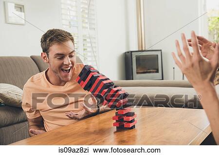 Couple playing wooden block building game View Large Photo Image Stock Image - Couple playing wooden block building game. Fotosearch
