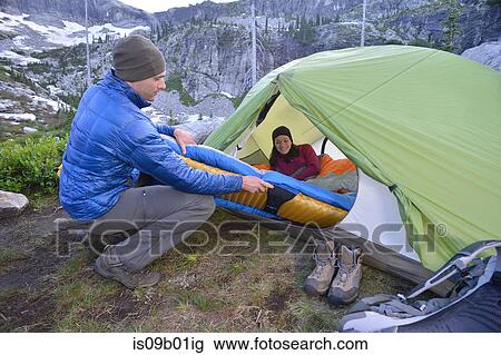 Couple putting sleeping bag in tent at dusk, Fault Lake, Selkirk Mountains, Idaho View Large Photo Image Stock Image - Couple putting sleeping bag in tent at dusk, Fault Lake, Selkirk Mountains, Idaho. Fotosearch