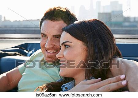 Couple relaxing in convertible car, Los Angeles, California, USA View Large Photo Image Picture - Couple relaxing in convertible car, Los Angeles, California, USA. Fotosearch