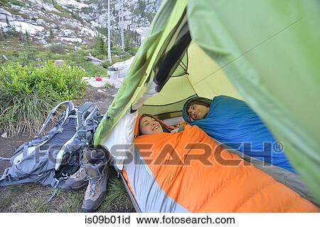 Couple relaxing in sleeping bags in tent at Fault Lake, Selkirk Mountains, Idaho View Large Photo Image Stock Image - Couple relaxing in sleeping bags in tent at Fault Lake, Selkirk Mountains, Idaho. Fotosearch