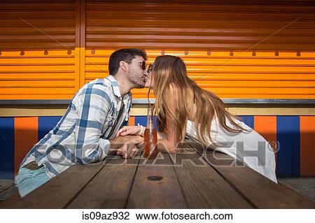 Couple sitting face to face at picnic table kissing, Coney island, Brooklyn, New York, USA View Large Photo Image Stock Image - Couple sitting face to face at picnic table kissing, Coney island, Brooklyn, New York, USA. Fotosearch