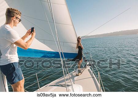 Couple taking photograph on sailboat, San Diego Bay, California, USA View Large Photo Image Stock Image - Couple taking photograph on sailboat, San Diego Bay, California, USA. Fotosearch