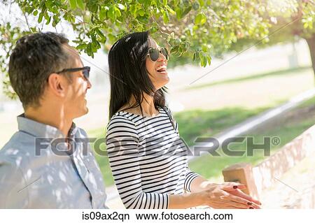Couple underneath tree laughing View Large Photo Image Picture - Couple underneath tree laughing. Fotosearch