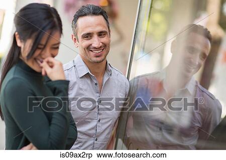 Couple window shopping laughing View Large Photo Image Stock Photography - Couple window shopping laughing. Fotosearch