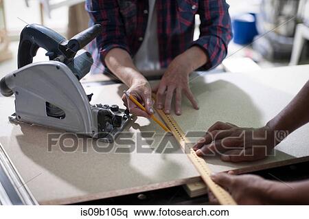 Cropped shot of carpenters marking measurements in furniture making workshop View Large Photo Image Stock Photography - Cropped shot of carpenters marking measurements in furniture making workshop. Fotosearch