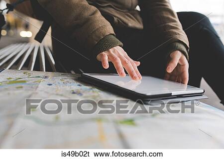 Cropped shot of female backpacker using digital tablet touchscreen on railway platform View Large Photo Image Stock Photograph - Cropped shot of female backpacker using digital tablet touchscreen on railway platform. Fotosearch