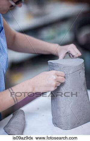 Cropped shot of female potters slicing clay in workshop View Large Photo Image Stock Photo - Cropped shot of female potters slicing clay in workshop. Fotosearch