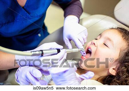Cropped view of girl in dentist chair having dental examination View Large Photo Image Stock Photography - Cropped view of girl in dentist chair having dental examination. Fotosearch