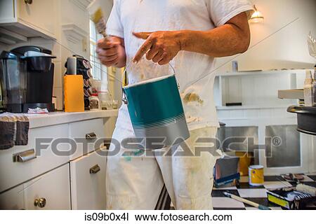 Cropped view of man in kitchen holding paint can View Large Photo Image Stock Image - Cropped view of man in kitchen holding paint can. Fotosearch