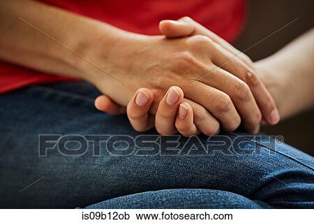 Stock Image - Cropped view of mother and son holding hands. Fotosearch