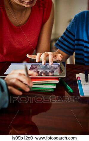 Cropped view of mother and son using digital tablet View Large Photo Image Stock Image - Cropped view of mother and son using digital tablet. Fotosearch