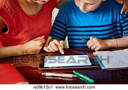 Cropped view of mother and son using digital tablet View Large Photo Image Stock Image - Cropped view of mother and son using digital tablet. Fotosearch