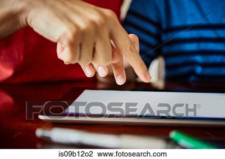 Cropped view of mother and son using digital tablet View Large Photo Image Stock Image - Cropped view of mother and son using digital tablet. Fotosearch