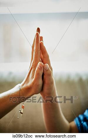 Cropped view of mother and son with hands together View Large Photo Image Stock Image - Cropped view of mother and son with hands together. Fotosearch