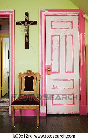 Crucifix and chair by door View Large Photo Image Stock Photo - Crucifix and chair by door. Fotosearch