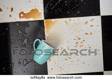 Cup on floor surrounded by spilt coffee, overhead view View Large Photo Image Stock Photo - Cup on floor surrounded by spilt coffee, overhead view. Fotosearch