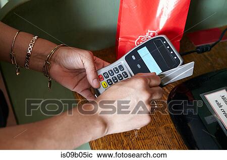 Customer in bakery paying for goods, using card machine, close-up View Large Photo Image Stock Image - Customer in bakery paying for goods, using card machine, close-up. Fotosearch
