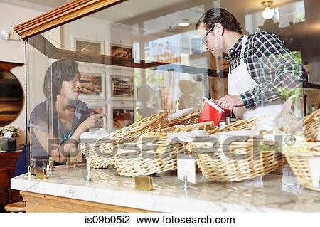 Customer in bakery pointing to baked goods View Large Photo Image Stock Image - Customer in bakery pointing to baked goods. Fotosearch