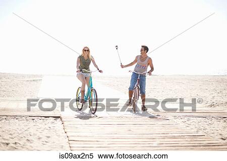 Stock Photography - Cycling man taking a selfie at Venice Beach, Los Angeles, California, USA. Fotosearch