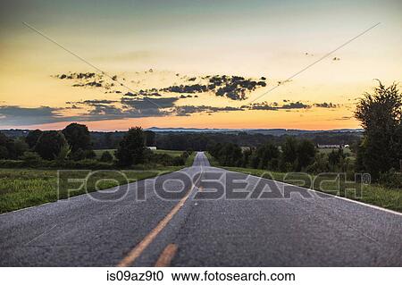 Diminishing perspective of rural road at sunset View Large Photo Image Stock Image - Diminishing perspective of rural road at sunset. Fotosearch