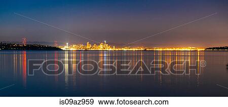 Distant panoramic view of city lights reflected in Puget Sound at night, Seattle, Washington, USA View Large Photo Image Stock Photo - Distant panoramic view of city lights reflected in Puget Sound at night, Seattle, Washington, USA. Fotosearch
