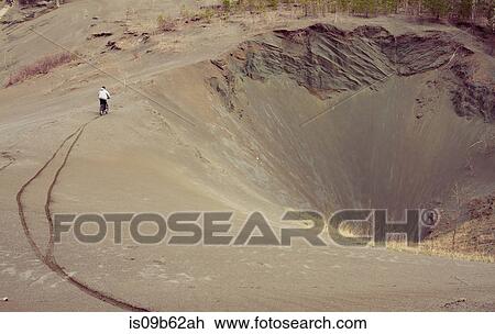 Distant view of male mountain biker mountain biking down quarry hill View Large Photo Image Stock Image - Distant view of male mountain biker mountain biking down quarry hill. Fotosearch