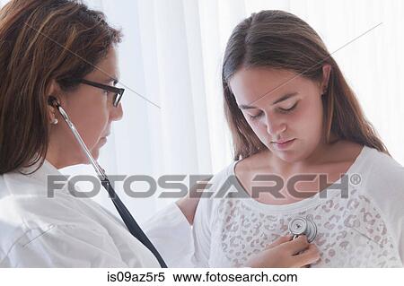 Doctor examining teenage girl View Large Photo Image Stock Photography - Doctor examining teenage girl. Fotosearch