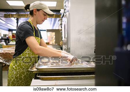 Employee in general store preparing bacon in kitchen View Large Photo Image Stock Photo - Employee in general store preparing bacon in kitchen. Fotosearch