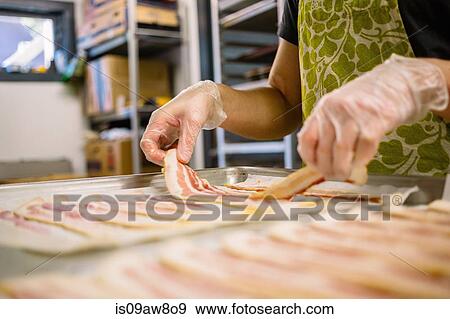 Employee in general store preparing bacon in kitchen View Large Photo Image Stock Photo - Employee in general store preparing bacon in kitchen. Fotosearch