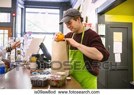 Employee in general store serving customer at counter View Large Photo Image Stock Image - Employee in general store serving customer at counter. Fotosearch