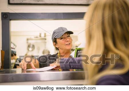 Employee in general store serving customer at counter View Large Photo Image Stock Image - Employee in general store serving customer at counter. Fotosearch