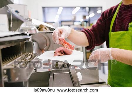 Employee in general store weighing sliced meat in kitchen View Large Photo Image Stock Photograph - Employee in general store weighing sliced meat in kitchen. Fotosearch