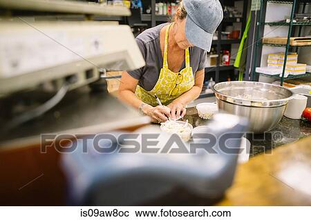 Employee in general store writing notes in kitchen View Large Photo Image Stock Image - Employee in general store writing notes in kitchen. Fotosearch