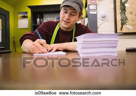 Employee in general store writing notes in office View Large Photo Image Stock Image - Employee in general store writing notes in office. Fotosearch