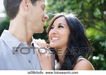 Engaged couple gazing at each other View Large Photo Image Stock Photo - Engaged couple gazing at each other. Fotosearch