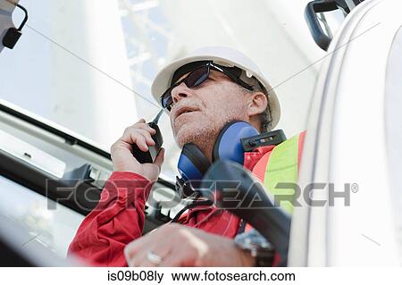 Engineer using walkie talkie on oil rig View Large Photo Image Stock Photo - Engineer using walkie talkie on oil rig. Fotosearch