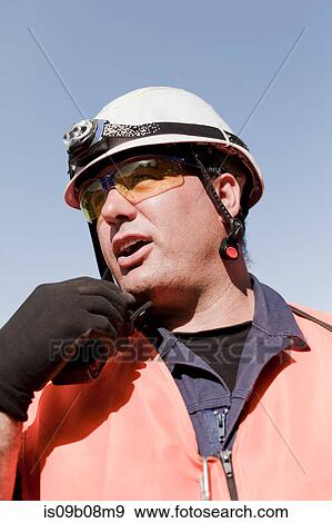 Engineer using walkie talkie on oil rig View Large Photo Image Stock Photo - Engineer using walkie talkie on oil rig. Fotosearch