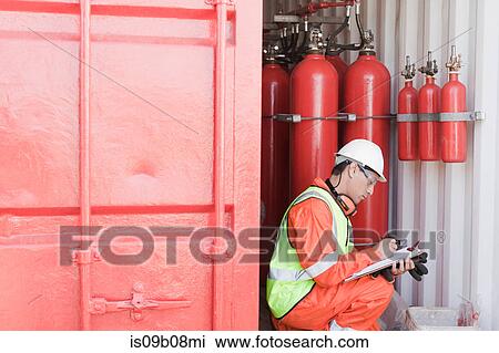 Stock Image - Engineer working on oil rig. Fotosearch