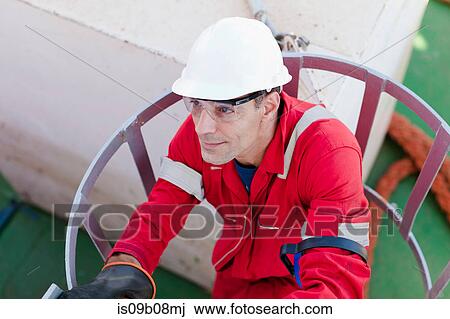 Engineer working on oil rig View Large Photo Image Stock Image - Engineer working on oil rig. Fotosearch