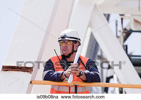 Stock Image - Engineer working on oil rig. Fotosearch