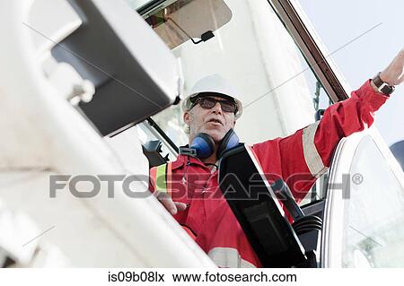 Stock Photo - Engineer working on oil rig. Fotosearch