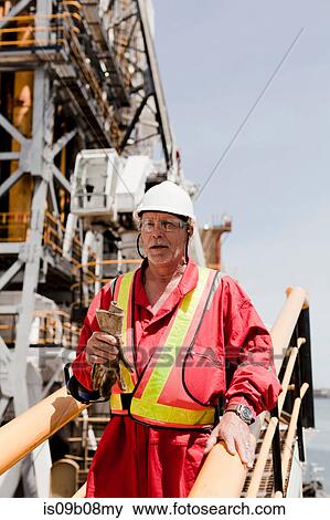 Engineer working on oil rig View Large Photo Image Stock Photo - Engineer working on oil rig. Fotosearch