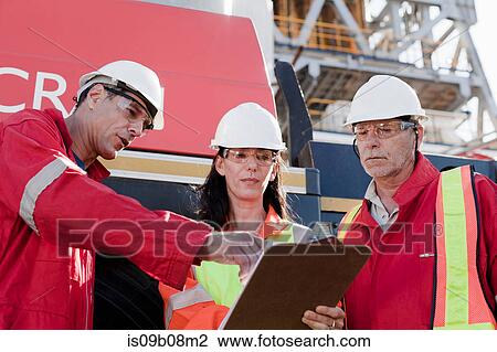 Engineers in brainstorming session on oil rig View Large Photo Image Stock Image - Engineers in brainstorming session on oil rig. Fotosearch