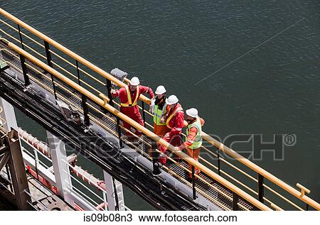 Engineers in brainstorming session on oil rig View Large Photo Image Stock Image - Engineers in brainstorming session on oil rig. Fotosearch